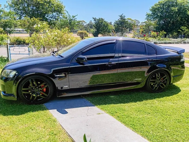 Black Holden Commodore with mirror finish